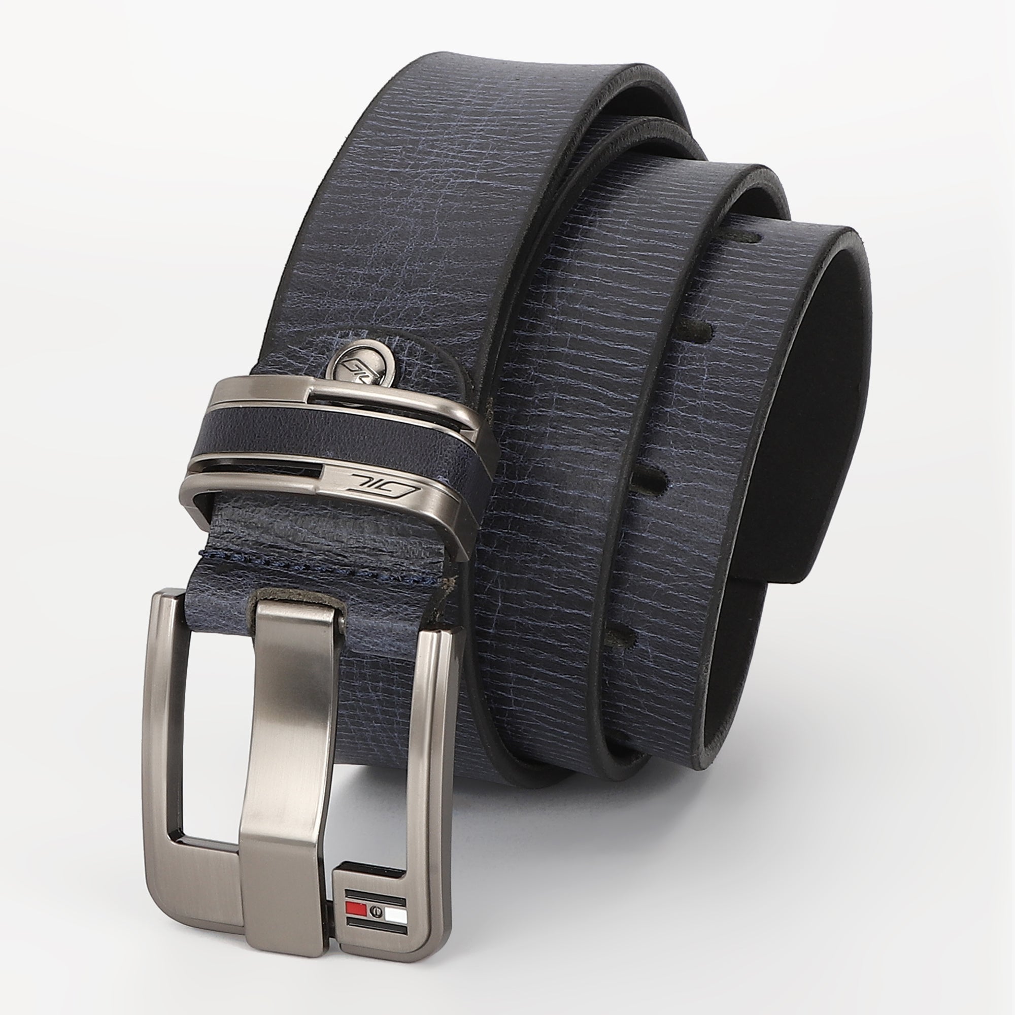 A dark navy blue textured leather belt with a silver-tone metal buckle, coiled on a light gray background. The buckle features a small GIL flag logo.